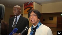 United Nations High Commissioner for Human Rights Navi Pillay,right, is flanked by Zimbabwe's Justice Minister while addressing journalists upon her arrival in Harare, Sunday, May, 20, 2012. 