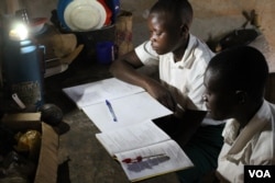 Michael Mugerwa’s students come to his house to study using his solar light, Kiwumu, Uganda, Feb. 28, 2014. (Hilary Heuler/VOA)
