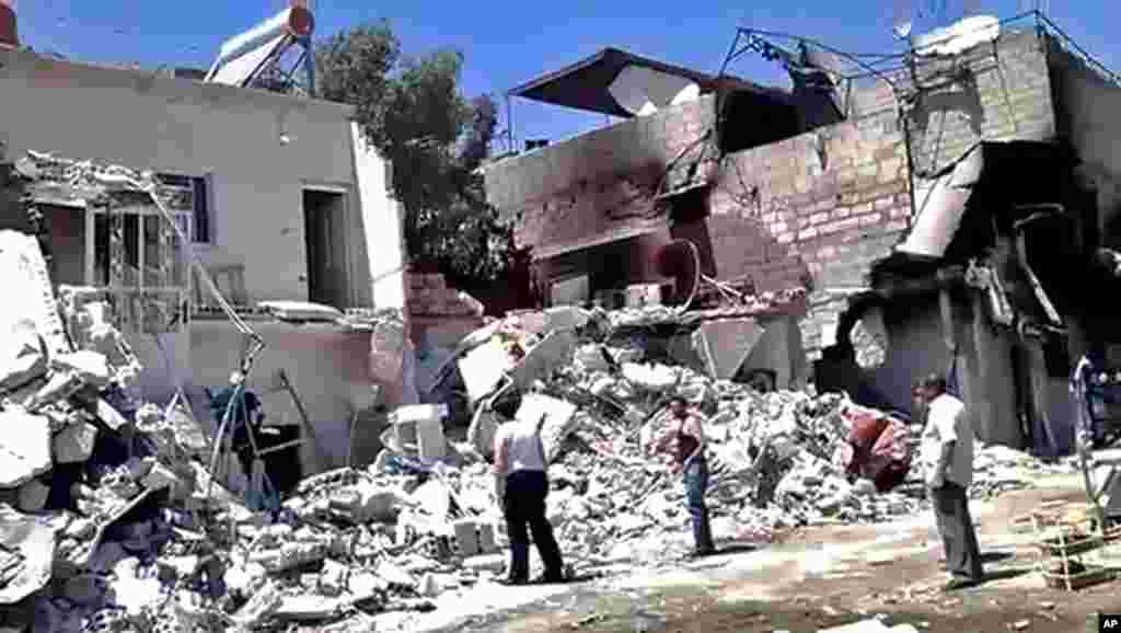 This citizen journalism image provided by Shaam News Network purports to show damage from heavy shelling of the al-Qadam district of Damascus, Syria, July 23, 2012.
