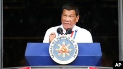 FILE - Philippine President Rodrigo Duterte gestures while addressing the crowd after leading the flag-raising rites at the 120th Philippine Independence Day celebration at the Emilio Aguinaldo Shrine at Kawit, Cavite province south of Manila, June 12, 2018.