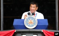 Philippine President Rodrigo Duterte gestures while addressing the crowd after leading the flag-raising rites at the 120th Philippine Independence Day celebration at the Emilio Aguinaldo Shrine at Kawit, Cavite province south of Manila, June 12, 2018.