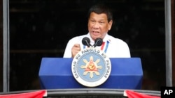 Philippine President Rodrigo Duterte gestures while addressing the crowd after leading the flag-raising rites at the 120th Philippine Independence Day celebration at the Emilio Aguinaldo Shrine at Kawit, Cavite province south of Manila, June 12, 2017. 