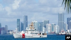 FILE - A U.S. Coast Guard ship leaves the coast guard base in Miami Beach, Fla., July 19, 2021. The Coast Guard was searching for 39 people on Jan. 25, 2022, after a boat capsized off the coast.