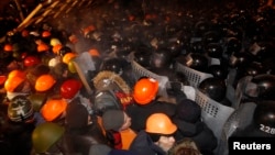 Pro-European integration protesters confront riot police at Independence Square in Kyiv, Ukraine, Dec. 11, 2013.