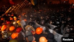 Pro-European integration protesters attempt to push back riot police at Independence Square in Kyiv December 11, 2013.