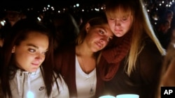 Umpqua Community College students join others at Stewart Park, in Roseburg, Oregon, for a candlelight vigil for those killed during a fatal shooting at the school, Oct. 1, 2015.