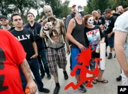 Juggalos, as supporters of the rap group Insane Clown Posse are known, gather in front of the Lincoln Memorial in Washington during a rally, Sept. 16, 2017, to protest and demand that the FBI rescind its classification of the juggalos as "loosely organize