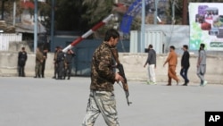 An Afghan security police walks in the site of explosion in Kabul, Afghanistan, March 21, 2019. 