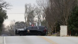 A law enforcement vehicle blocks the street to a synagogue where a man has reportedly taken people hostage in Colleyville, Texas, Jan. 15, 2022.