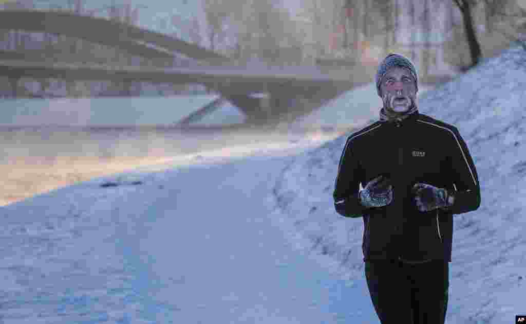A man with frost on his face runs along the banks of the Neris river as temperatures dipped to -18&ordm; C (- 0.4&ordm; F) in Vilnius, Lithuania.