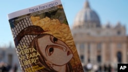 Pope Francis book on "Fake News", is pictured in front of St. Peter's Basilica, in Rome, Jan. 24, 2018.