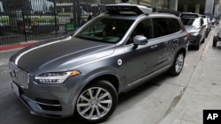 FILE - An Uber driverless car heads out for a test drive in San Francisco.