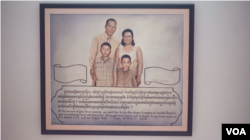 A painting representing Ros Sopheap's family as a gift from her GADC's colleagues is displayed at a wall along the stairway in her home. (Khan Sokummono/VOA Khmer)