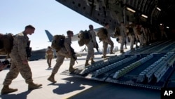 FILE - U.S. Marines board a military transport plane at Manas military base outside the Kyrgyz capital of Bishkek to be taken to Afghanistan, March 27, 2012. The U.S. plans to deploy about 300 Marines to Afghanistan this spring.