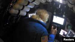 Undersea explorer Victor Vescovo pilots the submarine DSV Limiting Factor in the Pacific Ocean's Mariana Trench in an undated still image from video released by the Discovery Channel, May 13, 2019.