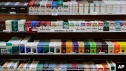 FILE - Cigarette packs are displayed at a smoke shop in New York.