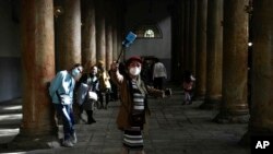 People visit the Church of the Nativity, traditionally believed to be the birthplace of Jesus Christ, on Christmas Day in the West Bank city of Bethlehem, Saturday, Dec. 25, 2021.