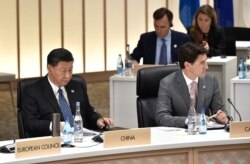 资料照：中国领导人习近平与加拿大总理特鲁多在日本大阪举行的G20峰会上。（2019年6月29日）