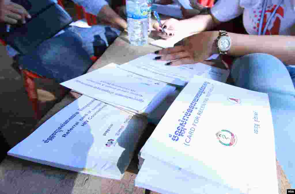 Test cards and health observation books used by health agents to conduct blood test for HIV infection to residents in Peam village, Kandal province, on Monday, Feb 22, 2016. (Photo: Aun Chhengpor/VOA Khmer)