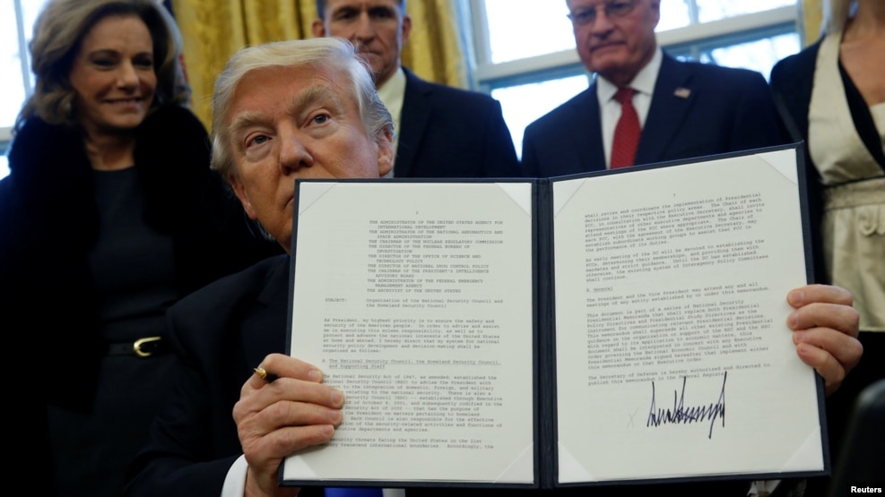 U.S. President Donald Trump holds an executive order dealing with the structure of the National Security Council after signing it in the Oval Office at the White House in Washington, Jan. 28, 2017. 