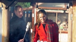 Britain's Prince William and Kate, Duchess of Cambridge toast marshmallows during a visit to meet students at the 'Christmas at the Castle' event held at Cardiff Castle, Wales, Tuesday Dec. 8, 2020, to hear how they have been supported with their mental h