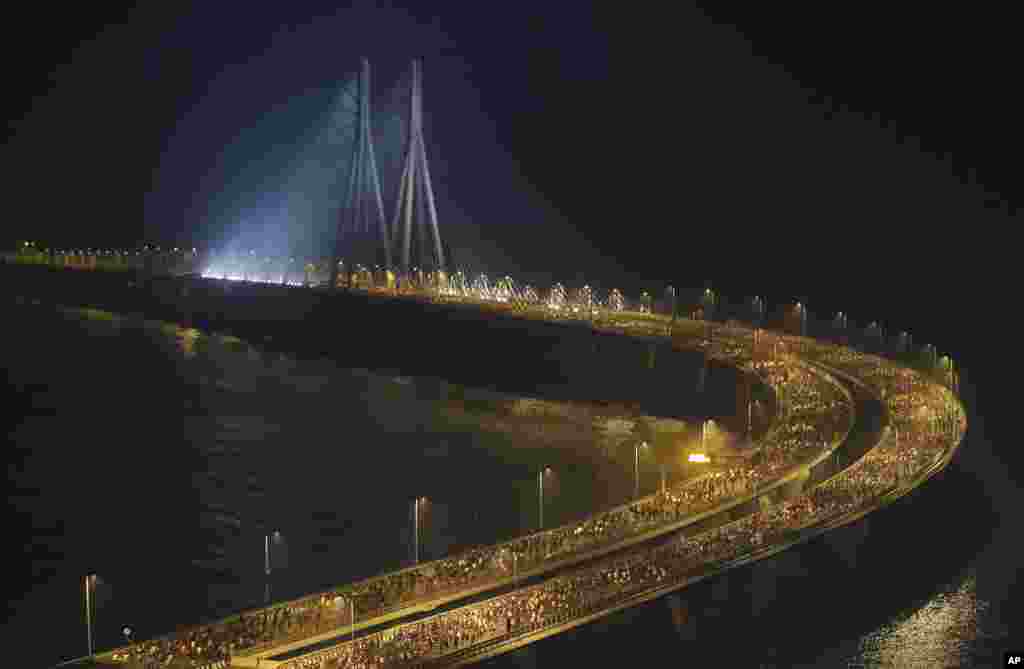 Runners compete along the Bandra-Worli sea link over the Arabian Sea during the Mumbai Marathon in Mumbai, India.