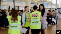 British Embassy staff assist in the evacuation of tourists at the Sharm el-Sheikh International Airport, south Sinai, Egypt, Nov. 6, 2015.
