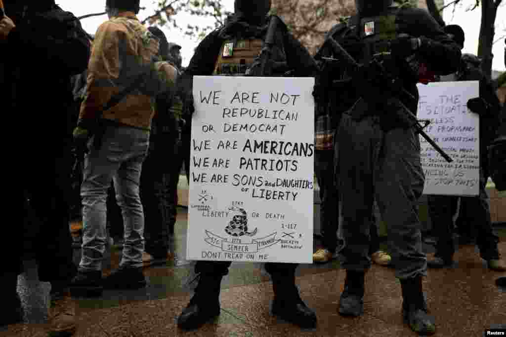 Militia groups gather to protect protesters as supporters of President Donald Trump protest against the election of President-elect Joe Biden, outside the Ohio State Capitol in Columbus, Jan. 17, 2021.