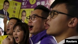 FILE - Alvin Yeung (2nd R), a candidate from Civic Party, chants slogans with supporters at a campaign rally during a legislative by-election in Hong Kong, China.