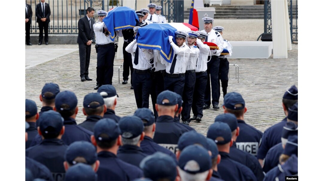 The flag-draped coffins of French police commander Jean-Baptiste Salvaing and his companion, administrative agent Jessica Schneider, are carried during a ceremony, in Versailles, near Paris, France, June 17, 2016.