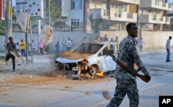 FILE - A Somali soldier attends the scene after a bomb attack near the office of the International Committee of the Red Cross in Mogadishu, Somalia, March 28, 2018.