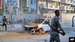 A Somali soldier attends the scene after a bomb attack near the office of the International Committee of the Red Cross in Mogadishu, Somalia, March 28, 2018. 