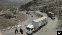 Border guards check trucks en-route to neighboring Afghanistan in Pakistan's tribal area of Khyber, July 4, 2012.