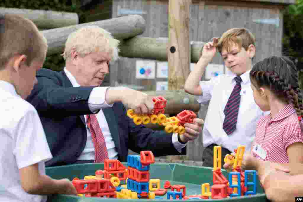 Britain&#39;s Prime Minister Boris Johnson reacts during his visit to The Discovery School in Kings Hill, south east England.