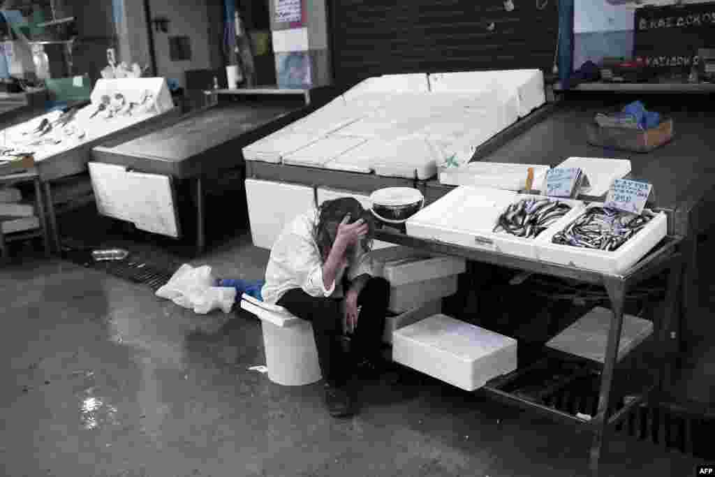 A man working at the central Fish market waits for customers in Athens on June 29, 2015. 