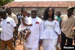 Julius Maada Bio, the presidential candidate for the Sierra Leone People's Party, arrives with his wife and daughter to cast his vote during a presidential run-off in Freetown, Sierra Leone, March 31, 2018.