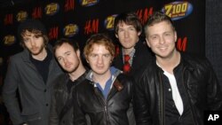 FILE - OneRepublic poses backstage at Z100's Jingle Ball