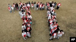 Students gather to form the "Pi" symbol, a Greek letter.