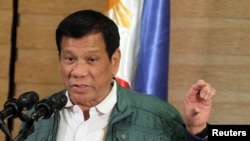 FILE - Philippine President Rodrigo Duterte speaks during a news conference in Davao.