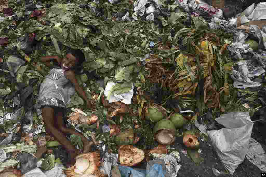 A child plays at a garbage dump near a market in Gauhati, India. 
