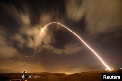 FILE - Iron Dome anti-missile system fires an interceptor missile as rockets are launched from Gaza towards Israel near the southern city of Sderot, Israel.