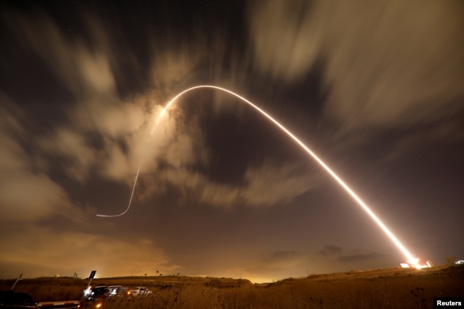 FILE - Iron Dome anti-missile system fires an interceptor missile as rockets are launched from Gaza towards Israel near the southern city of Sderot, Israel.