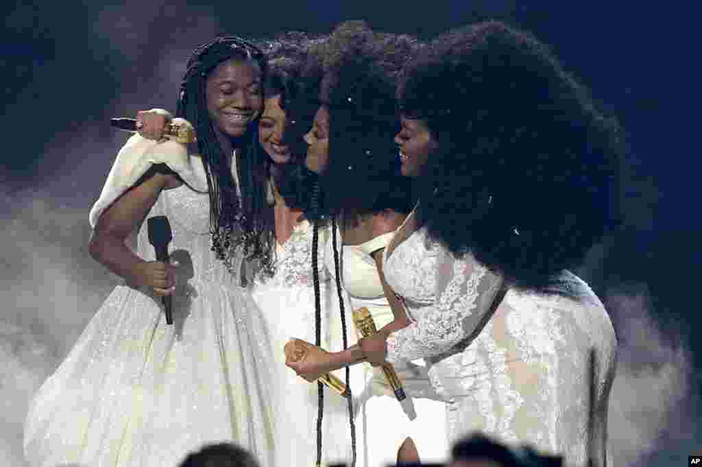 Faith Fennidy, from left, Madeline Edwards, Mickey Guyton, and Brittney Spencer embrace after a performance at the 55th annual CMA Awards, Nov. 10, 2021, at the Bridgestone Arena in Nashville, Tennessee.