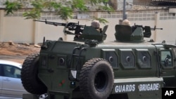 FILE - Nigerian soldiers patrol in an armored vehicle in Abuja, Nigeria, Feb. 7, 2015. 