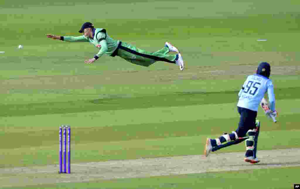 Ireland&#39;s Harry Tector, left, dives to make a catch but misses, during the third One Day International cricket match between England and Ireland, at the Ageas Bowl in Southampton, England.