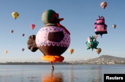 Hot-air balloons fly over the Palote dam during the "Hot Air Balloons Festival" in the city of Leon, in the state of Guanajuato, Mexico November 17, 2008. REUTERS/Mario Armas (MEXICO)