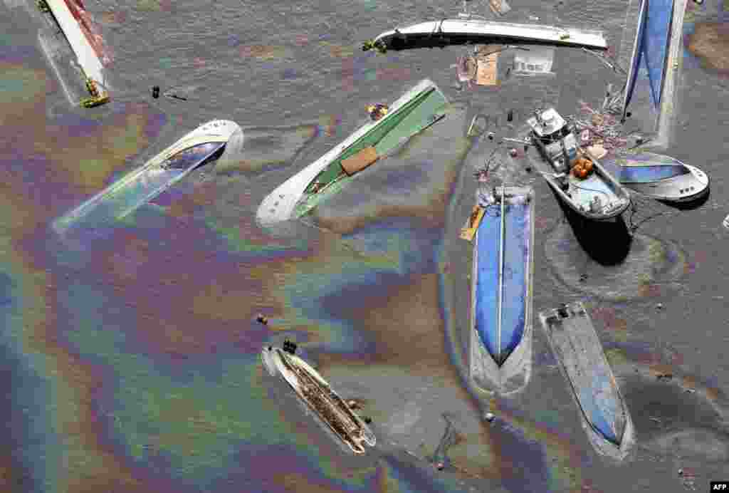 March 14: Vessels float on oil spilled water in Fudai, Iwate, northern Japan, following Friday's massive earthquake. (AP/Yomiuri Shimbun)