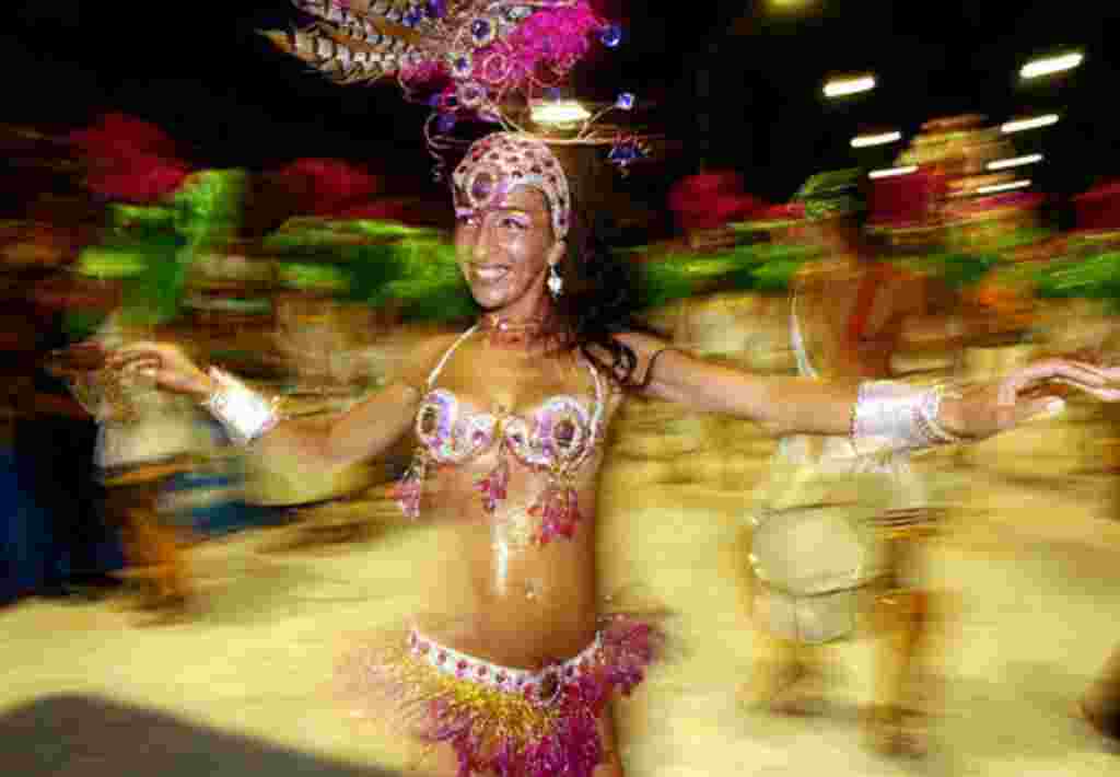 A dancer belonging to Ara Yevi masquerade group parades during the carnival in Gualeguaychu, some 230 km (142 miles) from Buenos Aires, Argentina, Sunday, Feb. 8, 2004. Gualeguaychu, a city in the province of Entre Rios,Argentina, is famous for its carn