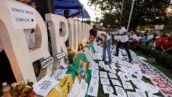 Friends and relatives light candles during a march paying homage to the victims of a mining dam collapse a week ago, in Brumadinho, Brazil, Feb. 1, 2019.