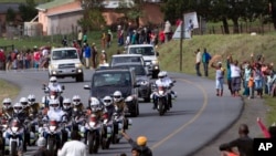 The funeral procession carrying the remains of former South African President Nelson Mandela proceeds to Mandela's hometown and burial site in Qunu, Dec. 14, 2013.